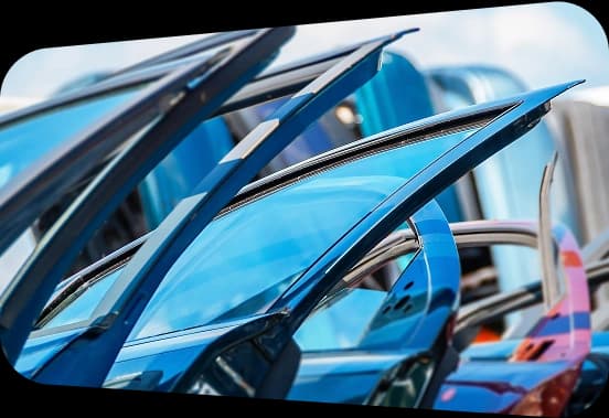 A person touching a car tire and checking its condition precisely